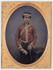 Soldier in ceremonial dress holding his sword  19th century.