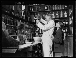 Chemist making cough mixture  1934.