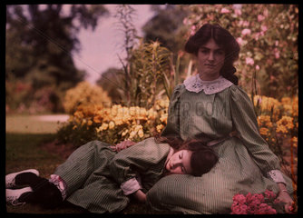 Two girls together in a garden  1908.