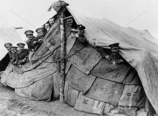 British soldiers looking out from their improvised tent  1914-1918.
