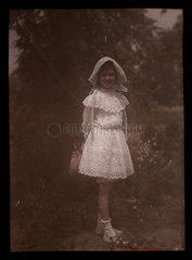 Girl wearing a bonnet and lace dress  1908.