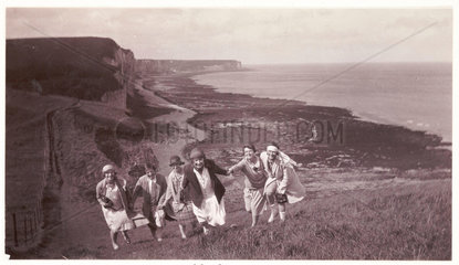 Women climbing a hill  c 1920.