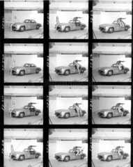 Contact sheet of nude models with Mercedes wing-door car  c 1961.