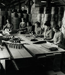 Female workers on line assemble inner segments for cardboard boxes 1956.