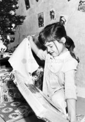 Katie Fisher opening a Christmas present  Cheshire  December 1984.
