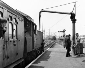 Steam locomotive taking on water  Wareham Station  Dorset  June 1965.
