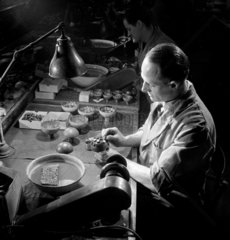 A worker sets lenses for polishing  Kershaw and Sons   Leeds  1953.