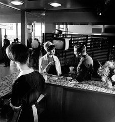 Cafeteria at Manchester Airport with waitress and couple having coffee  1965