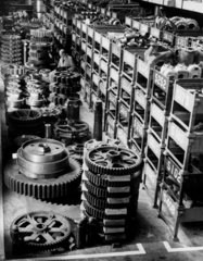 Long shot of storeman with large cogs stacked  Ransome and Rapier  1959.