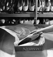 Close up of a hand packing box of Norvic Shoes  Norwich  1961.