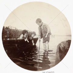 Small children playing at the waterside  c 1890s.