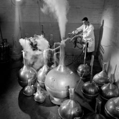 A worker cold shock tests copper vessels used in producing liquid oxygen.