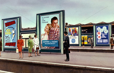 Advertisement hoardings at a London station  c 1962.