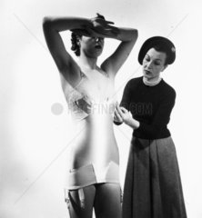 Model wearing an all-in-one bra and corset  c 1950s.
