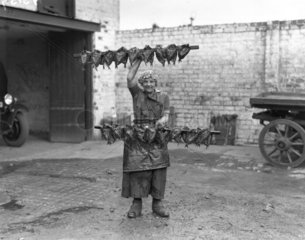 Kipper girl displaying smoked kippers  Scotland  24 September 1931.