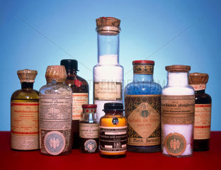 Group of nine bottles containing various chemicals  c 1920s.
