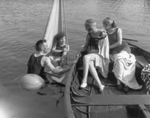 Two women in a boat talking to a couple in
