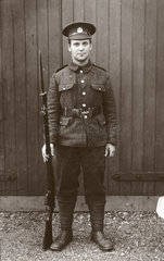 Soldier in uniform posing with his rifle  1914-1918.