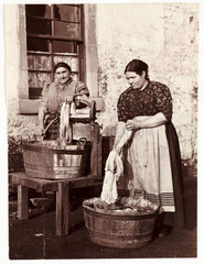 Two women washing clothes  c 1905.
