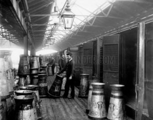 Midland Railway porters unloading milk at Somers Town dock  c 1890.