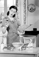 Woman making a cake  c 1950