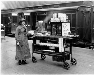 An attendant with the 'Snack Box' refreshment trolley  19 April 1921.