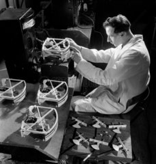 A production worker assembles scales at a plastics factory in Muswell Hill  1953