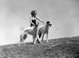 Young woman with two borzoi dogs  c 1930s.