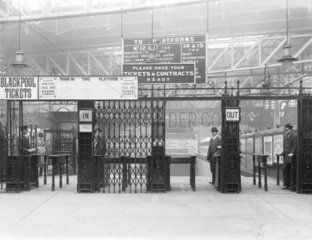Ticket gate at a London  Midland & Scottish Railway station  c 1924.