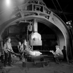 A group work on the hammer forge on a part for a diesel locomotive Darlington.