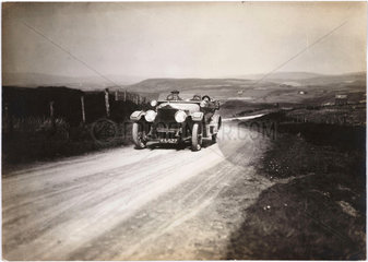 Motor car on a country road  c 1912.