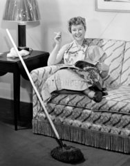 Woman sitting smoking a cigarette  1950.