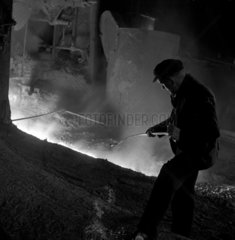 Unprotected steelworker with molten iron  Workington  1952.