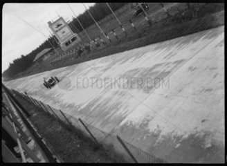 A racing car on the Nurburgring track  Germany  c 1935.