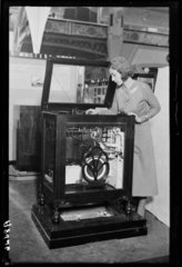 Woman looking into a radiogram at Radiolympia  Olympia  London  1932.