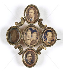 Family photographs in an elaborate frame  mid-late 19th century.