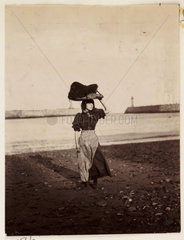 A woman carrying fishing equipment  Whitby  North Yorkshire  c 1905.
