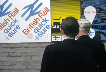Two men looking at British Rail posters  April 1964.