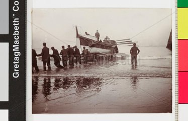 Launching of the Whitby No 2 lifeboat from the beach  c 1900s.