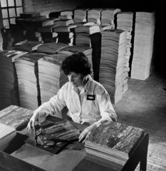 A female employee of Phoenix Rubber checks floor tiles  Slough  1964.