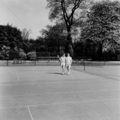 Two men leaving a tennis court  1955.