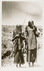 Two masked hunters  c 1925.