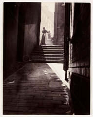 Shadows in an alleyway  c 1905.