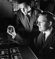 Mullard engineers discuss an integrated circuit starting master  1963.
