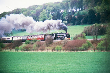 Steam locomotive pulling a passenger train.
