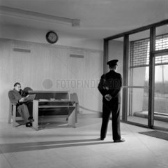 A commissionaire stands in Imperial Typewriter Company lobby  Hull.