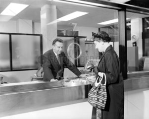 Woman buying a ticket at Liverpool Street station  London  17 June 1964.