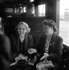 Women sitting in a carriage talking during their journey  1950.