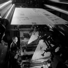 A print worker checks the gate of a newspaper printing machine  Bolton.