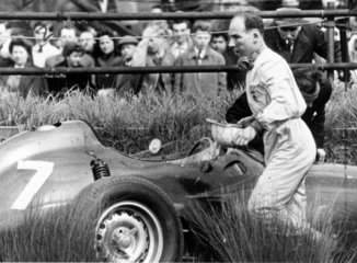 Stirling Moss walking away from his crashed BRM motor car  1959.